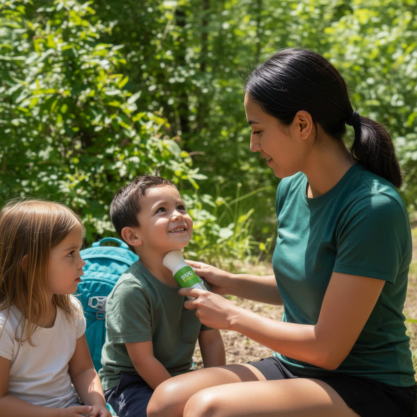 Mom brushing Bug Brush DEET free mosquito repellent powder onto her smiling son's chin on a wooded trail