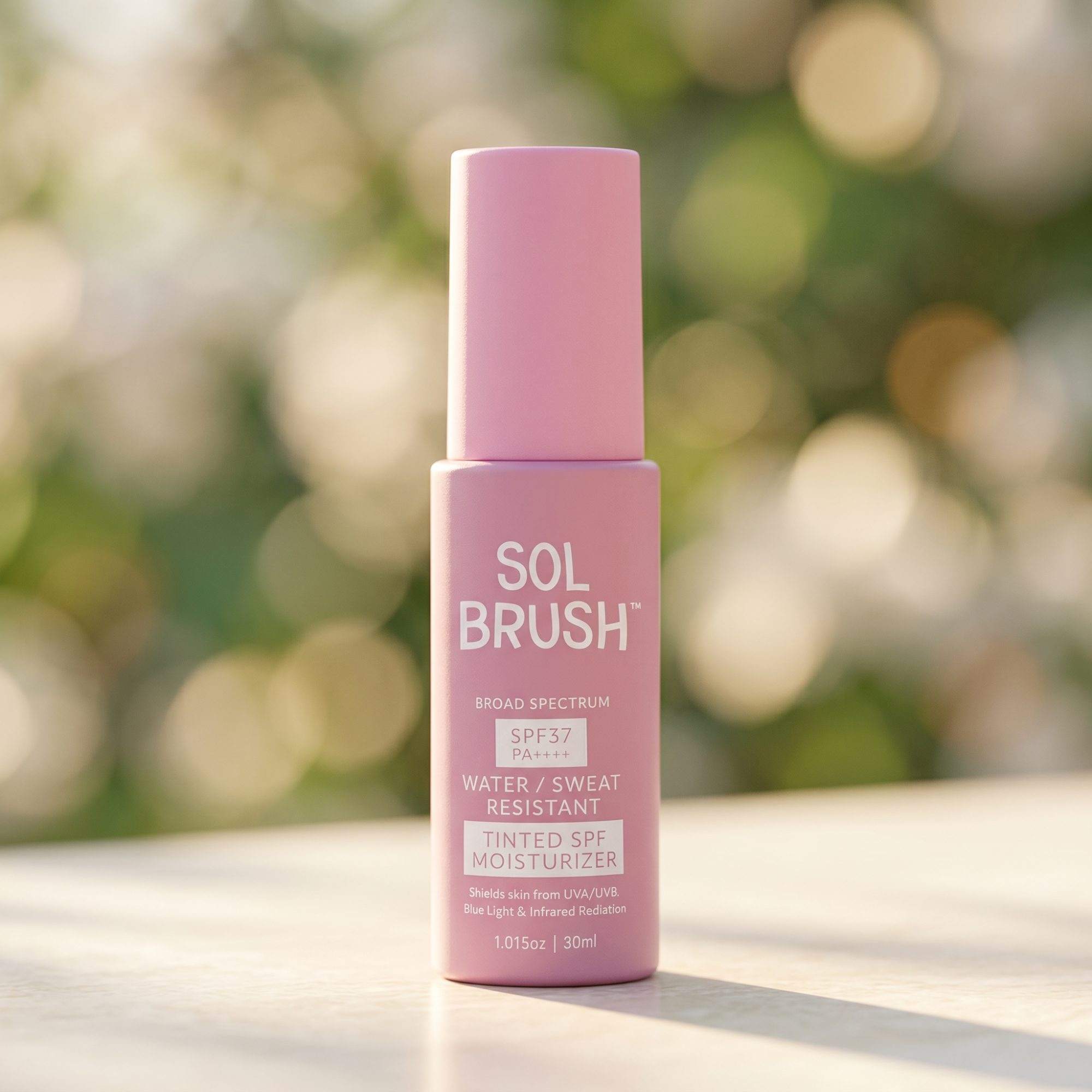 Pink Tinted SPF Moisturizer Broad Spectrum SPF 37 bottle standing on a table in soft garden light